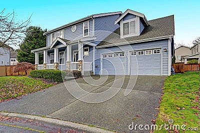 Charming blue two story home with a nice covered porch. Stock Photo