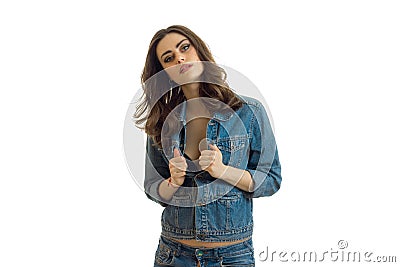 Charming brunette in jeans jacket posing in Studio Stock Photo