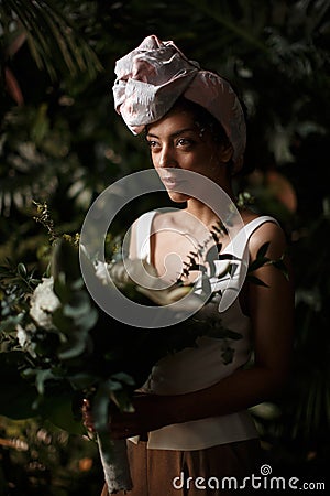 Charming calm curly hair, dark - skinned woman in white Stock Photo