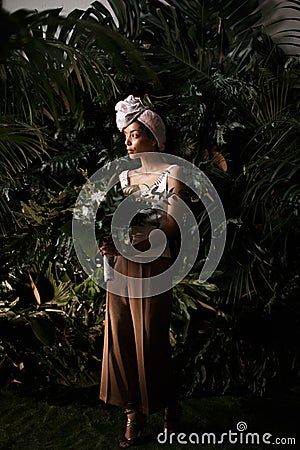 Charming calm curly hair, dark - skinned woman in white Stock Photo