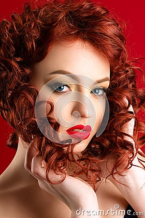 Charming caucasian woman with red hair and bright makeup Stock Photo