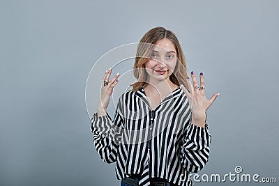 Charming caucasian young blonde woman showing ten fingers, smiling Stock Photo