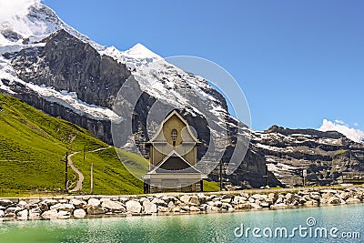 Chilchli tiny church at Fallbodensee lake along Jungfrau Eiger Walk Stock Photo