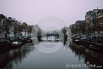 Charming cityscape of old Dutch town Haarlem. Stone bridge connecting two banks of the Spaarne river. Editorial Stock Photo