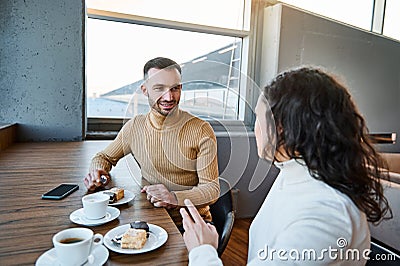 Charming couple in love snacking together in the international airport cafeteria, awaiting customs and passenger control before Stock Photo