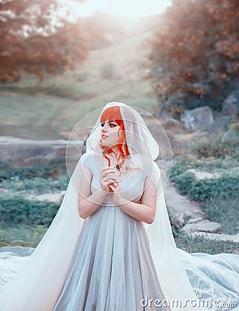 Charming elf bride waiting for her groom, girl with bright orange red tangerine hair and bangs, lady in long bright Stock Photo