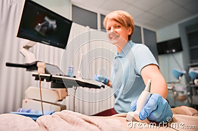 Charming female doctor doing ultrasound examination in clinic. Stock Photo