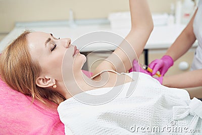 Charming female getting lipolytic procedure to burn body fat in aesthetic clinic Stock Photo