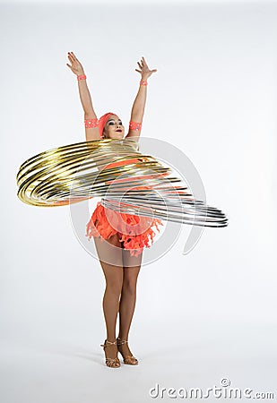 A charming girl performs circus elements with a hula Hoop Stock Photo