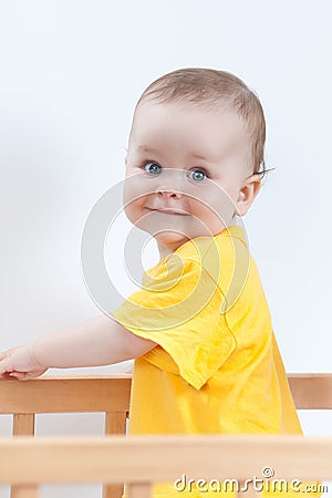 Charming kid in the crib Stock Photo