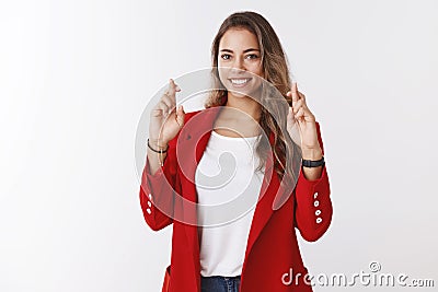 Charming lucky cute woman high hopes pass job interview successfully cross fingers for good luck, hopefully smiling Stock Photo