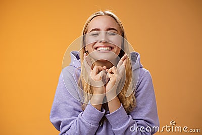 Charming lucky cute young happy hopeful blond girl close eyes smiling positive cross fingers good luck wanna win Stock Photo