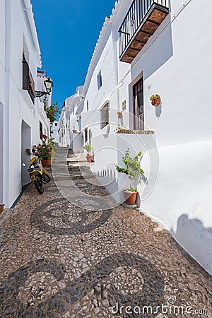 Charming narrow historic streets of white village Frigiliana. Stock Photo