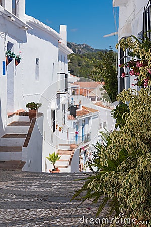 Charming narrow historic streets of white village Frigiliana. Stock Photo