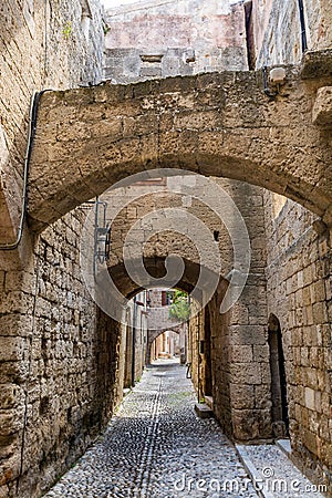 Charming narrow street in the old town of Rhodes, Greece Stock Photo