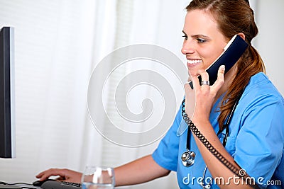 Charming pretty nurse looking on computer Stock Photo