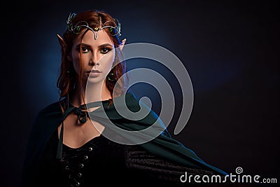 Charming queen of elves in silver tiara and red hair. Stock Photo