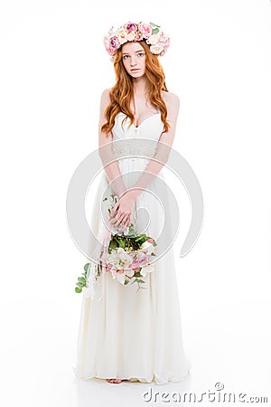 Charming redhead woman in dress holding flowers Stock Photo