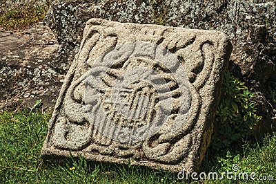 Charming and shabby family coat of arms carved on stone Stock Photo