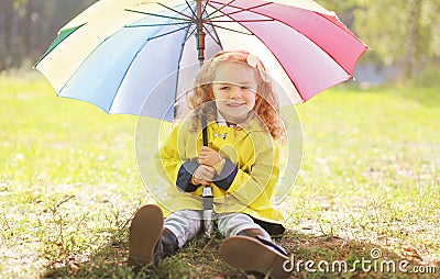 Charming smiling little girl with colorful umbrella Stock Photo
