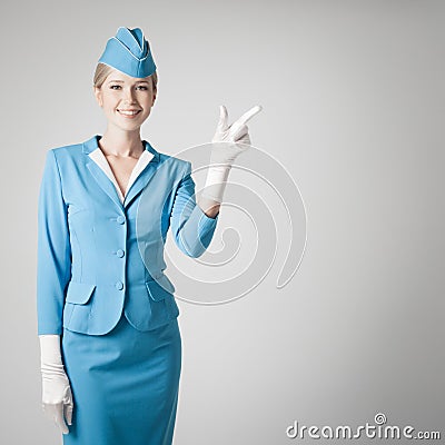 Charming Stewardess In Blue Uniform Pointing The Finger Stock Photo