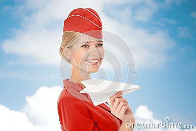 Charming Stewardess Holding Paper Plane In Hand. Stock Photo