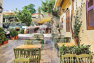 Charming street with cafe bars in old district of Plaka in Athens, Greece, popular travel destination Stock Photo