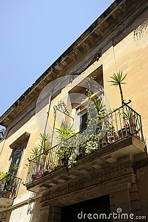 Charming streets of Lecce. Balcony flowery against blue sky. Lecce, Puglia, Italy Stock Photo