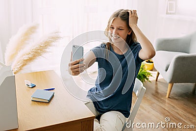 A charming student communicates with friends via video link, discusses a school or university project. Online Stock Photo