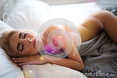 Charming tender woman lies in bedclothes Stock Photo