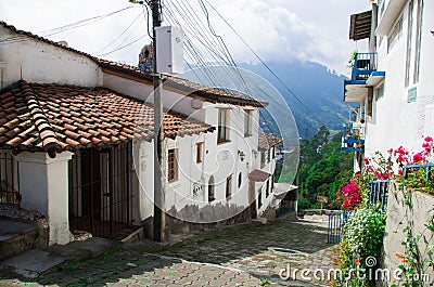 Charming village located outside Quito Ecuador with bridgestone road leading down to dome tower of spanish colonial Stock Photo