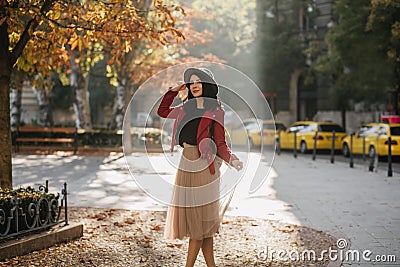 Charming white girl in romantic outfit dreamy posing in september day. Outdoor glad european lady in beige skirt Stock Photo