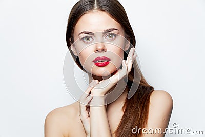 Charming woman Bare shoulders hands near Faces red lips attractive look bright makeup Stock Photo