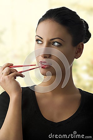Charming woman with chopstick Stock Photo