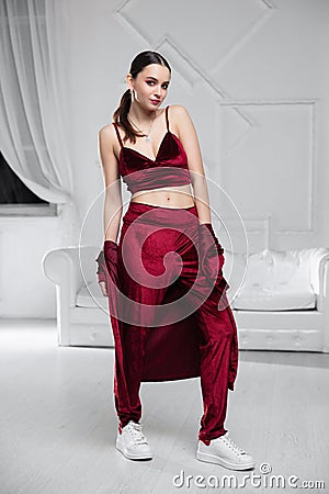 Charming woman dressed in a burgundy velvet suit Stock Photo