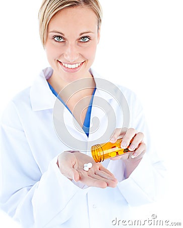 Charming young doctor holding pills Stock Photo