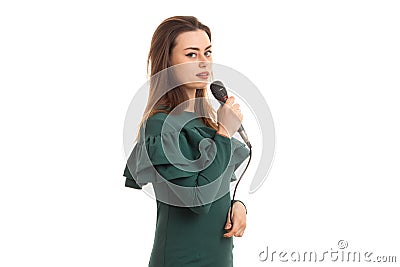 Charming young girl sings in karaoke with microphone in hand Stock Photo