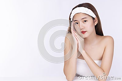 Charming woman wear headband touching her face with clean fresh body. Teenager before bathing while looking at camera over Stock Photo