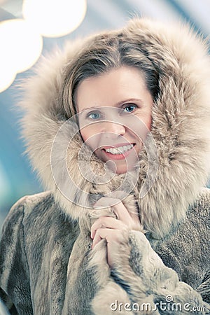 Charming young woman in a winter fur coat Stock Photo