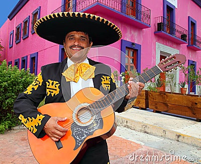 Charro Mariachi playing guitar Mexico houses Stock Photo