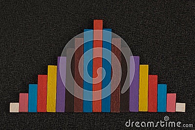 Chart of colored wooden pieces. Multicolor triangle. Abstract on black background Stock Photo