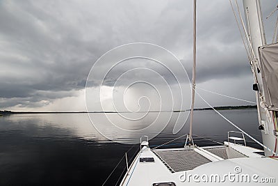 Charter Catamaran on Calm Water Before Rain Storm Stock Photo