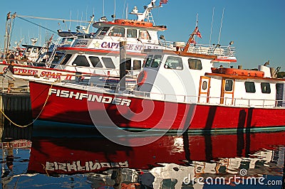 Charter fishing boats are moored at a commercial dock Editorial Stock Photo