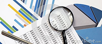 Many charts and graphs with pen and magnifier. Concept image of data gathering and statistical working Stock Photo