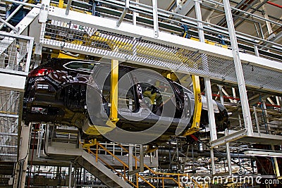 The chassis of a Vauxhall Astra suspended on the production line of the Vauxhall factory at Ellesmere Port Cheshire July 2011 Editorial Stock Photo