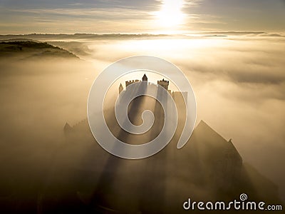Chateau Beynac in fog in the early morning Perigord Noir Dordogne France Stock Photo