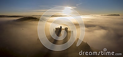 Chateau Beynac in fog in the early morning Perigord Noir Dordogne France Stock Photo