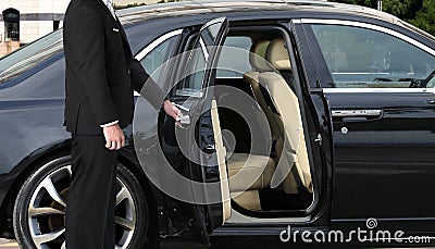 Chauffeur opening car door Stock Photo