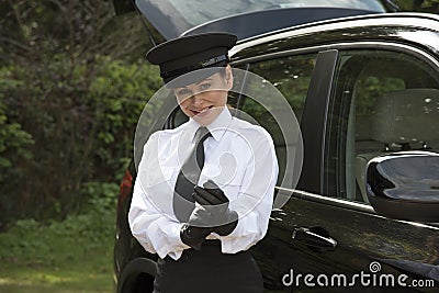 Chauffeur putting on her driving gloves Stock Photo