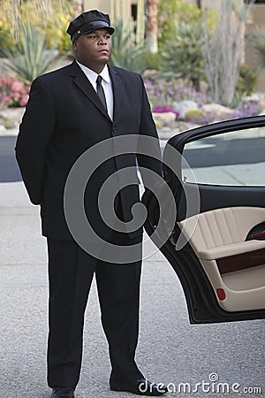 Chauffeur Waiting By Open Car Door Stock Photo